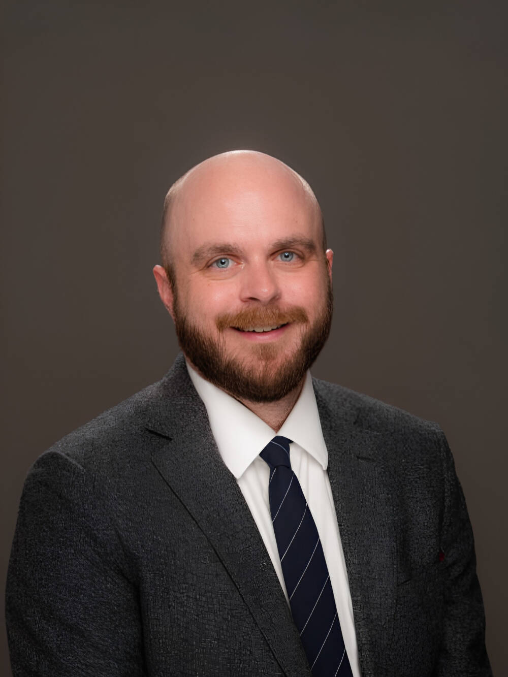 Justin Melick smiling for a professional photo